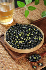 Crispy Fried Salted Black Beans Traditional Northeastern Asian Snack in Wooden Bowl