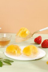 Crystal Dumplings with Sweet Golden Filling and Fresh Strawberries on White Plate