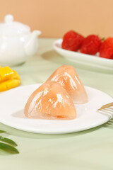 Crystal skin dumplings with sweet rice filling and fresh strawberries on elegant white dinnerware