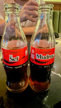 COca colaTwo whimsical soda bottles labeled Sef and Mudrac, perfect for Friendship Day in Serbia, latent message exchange