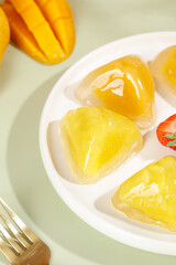 Heart-shaped crystal mango dumplings with fresh fruit dessert presentation