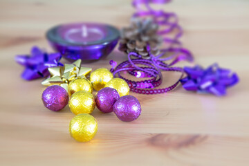 Christmas holiday decoration, purple and yellow golden sweet candy balls, candle