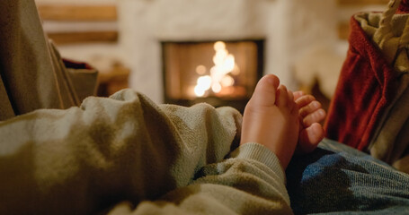 Baby's feet dangle from a hammock, providing a warm, cozy feel as the fireplace crackles behind....