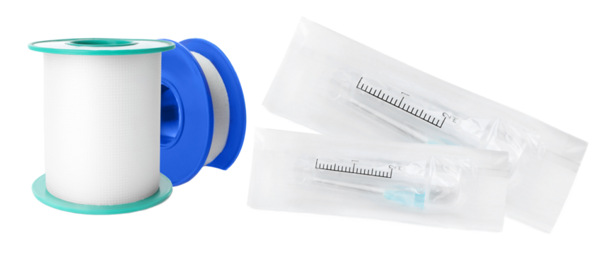 a photograph showing rolls of white porous surgical medical tape with a blue plastic spool next to two individually packaged sterile disposable syringes.