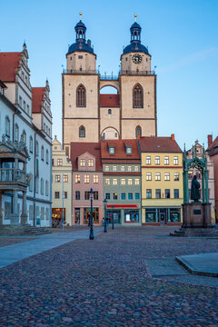 Market square with town church and old town hall during blue hour in Lutherstadt Wittenberg, Germany.