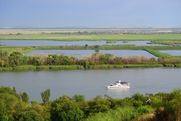 A pleasure yacht sails on the Don River. The natural landscape.