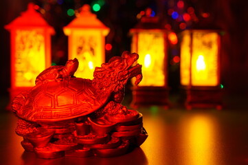 A dragon turtle statuette and New Year's burning lanterns.