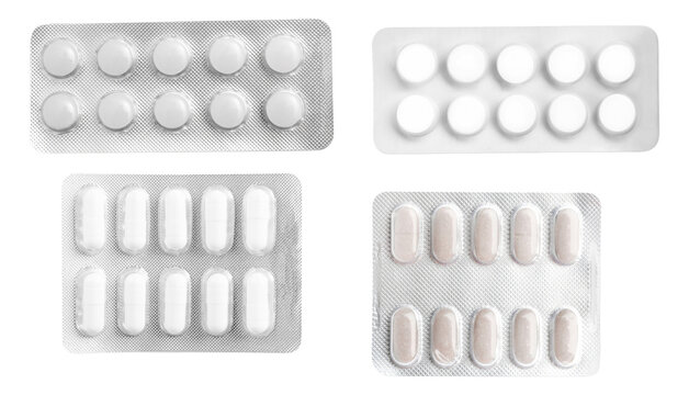 collection of four different types of white and light-colored pharmaceutical pills and capsules stored securely within silver blister packs, isolated on black.