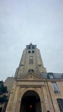 xtreme low-angle vertical shot of bell tower above stone entrance.