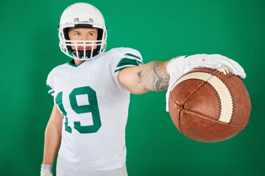 Portrait of American football player with ball and sports gear