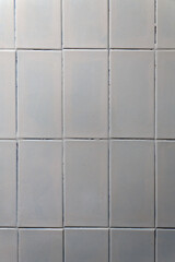 White vertical wall tiles with dark grout lines