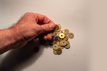 Hand picking up japanese 5 yen coins