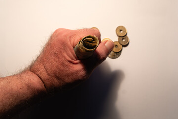 Hand gripping rolled japanese yen with coins