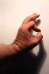 Hand making okay gesture with finger shadow