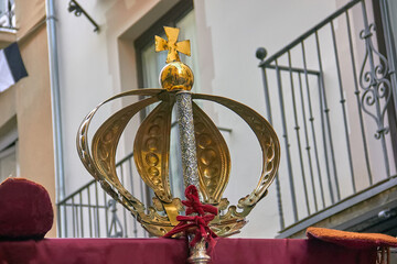 Golden crown with a cross on top, part of a religious float during the Virgen del Rosario procession in Granada, Spain. Faith, tradition.