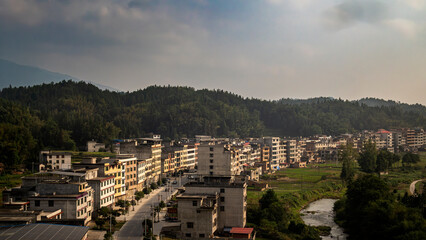 Riverside Town Surrounded by Forested Mountains
