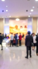 Blurred crowd gathers at an indoor event