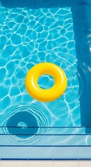 A yellow inflatable ring floats peacefully atop the clear, refreshing blue water of a pool. A scene of pure summertime relaxation.