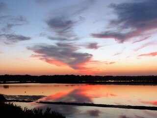 Fototapeta premium Breathtaking Evening Atmosphere on a Mediterranean Lake with Spectacular Cloud Reflections and Intense Sunset Colors