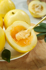Sweet Yellow Melons with Fragrant Flesh Served on White Plate with Golden Spoon