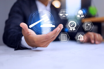 Legal concept with businessman holding a judge hammer icon represent to implement a law ethic or...