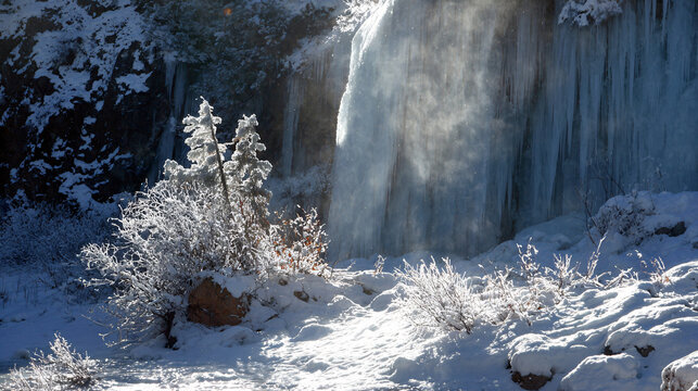 Christmas frozen waterfall sparkling in sunlight  - Powered by Adobe