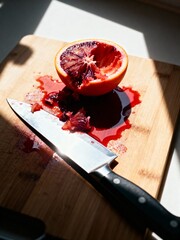 Juicy Blood Orange on a Cutting Board. Vibrant, fresh, and messy.