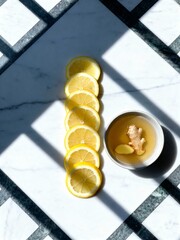 Minimalist Ginger and Lemon Tea Composition. A study in light and shadow.
