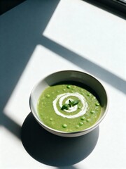 Minimalist Green Pea Soup with Cream Swirl. A fresh and simple dish.
