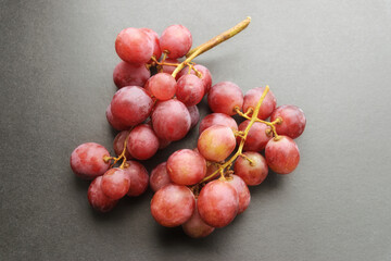 Fresh red grapes on dark background.