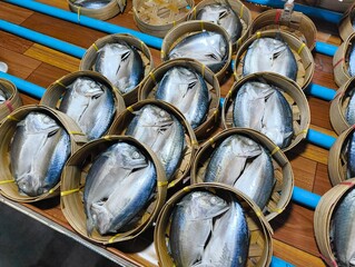 Pack of Short-bodied mackerel with bamboo steamer basket in Thai fresh market.