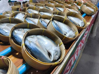 Pack of Short-bodied mackerel with bamboo steamer basket in Thai fresh market.