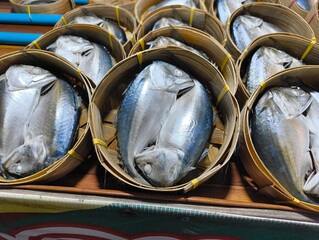 Pack of Short-bodied mackerel with bamboo steamer basket in Thai fresh market.