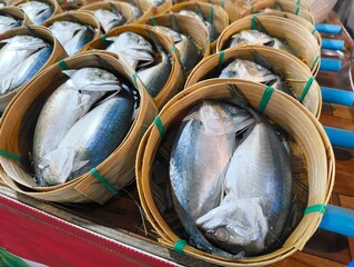 Pack of Short-bodied mackerel with bamboo steamer basket in Thai fresh market.