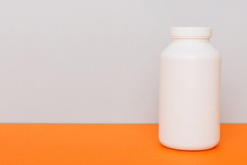 supplement pills with medicine bottle health care and medical top view. Vitamin tablets. Top view mockup bottle for pills and vitamins with green leaves, natural organic bio supplement, copy space