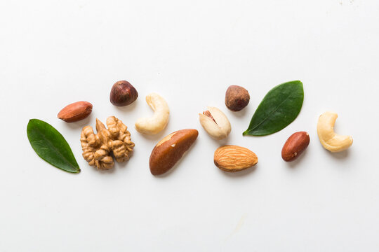 Composition of nuts , flat lay - mix hazelnuts, cashews, almonds on table background. healthy eating concepts and food background