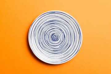 Top view of isolated of colored background empty round blue plate for food. Empty dish with space for your design