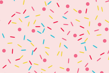 A light pink background covered in a pattern of colorful sprinkles and dots.