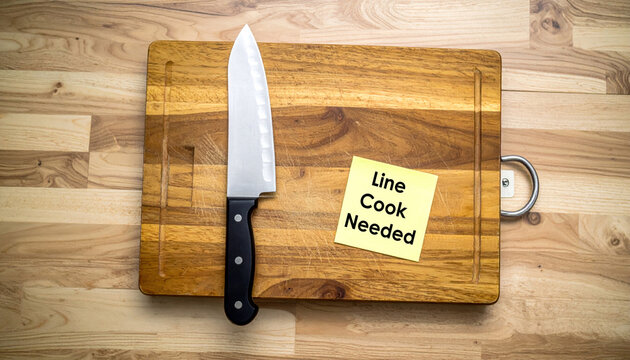 Urgent hiring ad for line cook on kitchen cutting board. concept showing job market crisis and culinary industry ongoing labor shortages and demand for staff