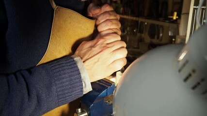 Close-up of artisan using a gouge to carve wood in a well-lit workshop, hands gripping tool with controlled precision.​ - Powered by Adobe