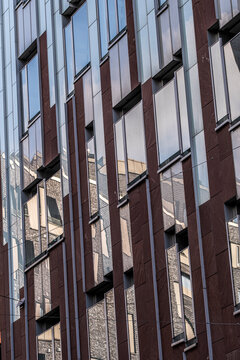 Abstract geometry of a modern facade where minimal structure and pattern combine with reflection and texture to express refined architectural design simplicity