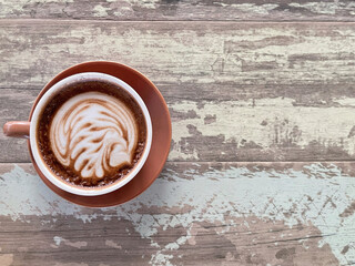 A cup of hot Mocha on a wooden table