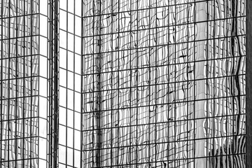 Minimal black and white modern architecture showing geometric pattern detail and structural texture across a balanced symmetrical facade