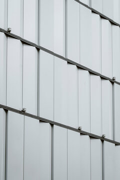 Black and white modern architecture facade pattern showing geometric structure and detailed texture with minimal symmetry captured from an oblique angle