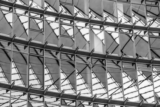 Minimal architectural facade in black and white focusing on texture, geometry and structure forming a symmetrical modern pattern composition