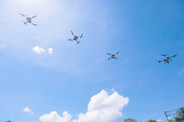 Agricultural Drones Flying in Formation Under Bright Blue Sky