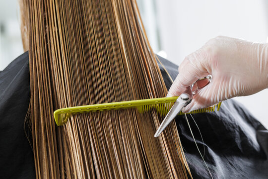 Precision wet haircut with comb tension and scissors in professional salon