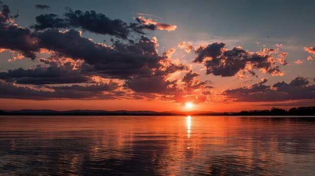 Majestic sunset over peaceful lake reflecting colorful clouds and warm hues in serene evening atmosphere