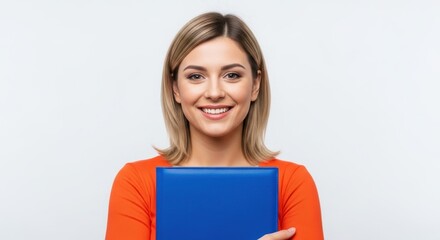 A cheerful young adult businesswoman or student with blonde hair smiling happily while holding a blue folder on a white background