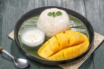 Mango sticky rice is a Thai dessert made from sticky rice, mango and coconut milk.